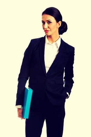 Smiling businesswoman holding a binder.の写真素材