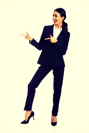 Businesswoman pointing to the left with both hands.の写真素材