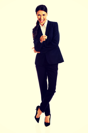 Smiling businesswoman pointing at you.の写真素材