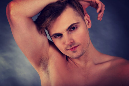 Young shirtless muscular man smiling to camera.の写真素材