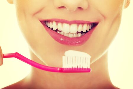 Young woman holding a toothbrush.の写真素材