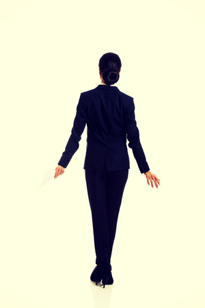 Businesswoman with paper sheet back to cameraの写真素材