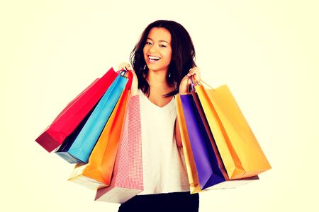 Young happy smiling woman with shopping bags.の写真素材