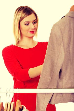 Young woman deciding what to put on.の写真素材