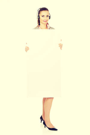 Beautiful smiling call center woman with empty banner.の写真素材