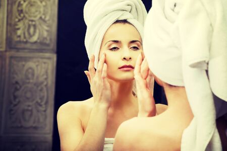 Beautiful woman take care of her face.の写真素材