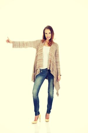 Beautiful smiling woman showing thumbs up.の写真素材