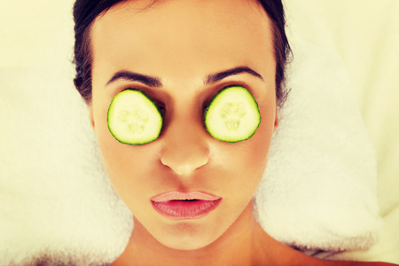 Woman in spa with cucumber on eyes.の写真素材