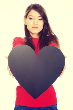 Young student woman with heart made from paper.の写真素材