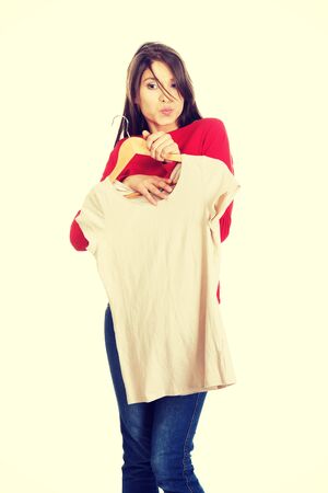 Happy young woman with a new shirt.の写真素材