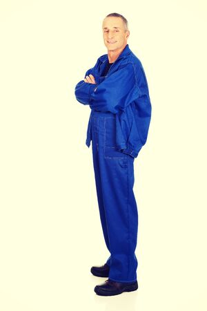 Smiling mature repairman with folded arms.の写真素材
