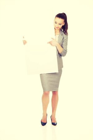 Beautiful business woman presenting empty banner.の写真素材