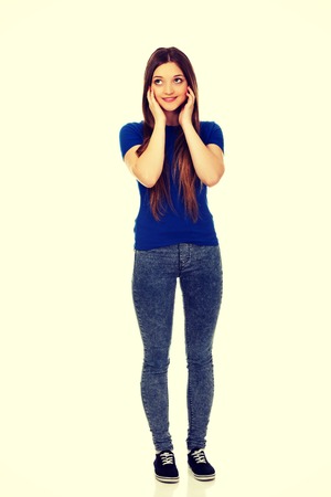 Beautiful happy thoughtful woman looking up.の写真素材