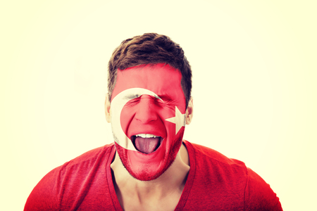 Screaming man with Turkey flag painted on face.の写真素材