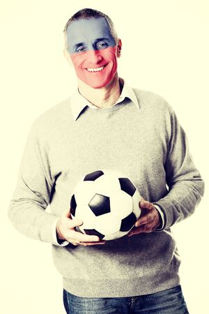 Mature man with Liechtenstein flag painted on face.の写真素材