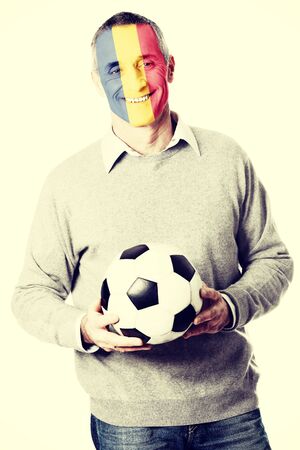 Mature man with Romania flag painted on face.の写真素材