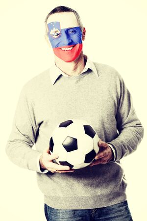 Mature man with Slovenia flag painted on face.の写真素材