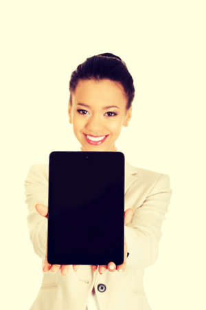 Beautiful african business woman showing the tablet.の写真素材