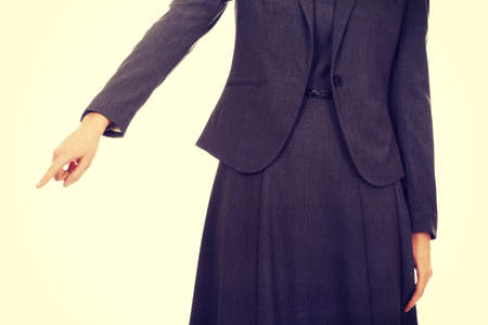 Beautiful young businesswoman pointing down.の写真素材