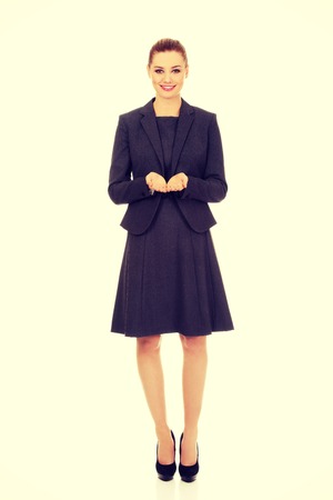 Happy business woman showing empty hands.の写真素材