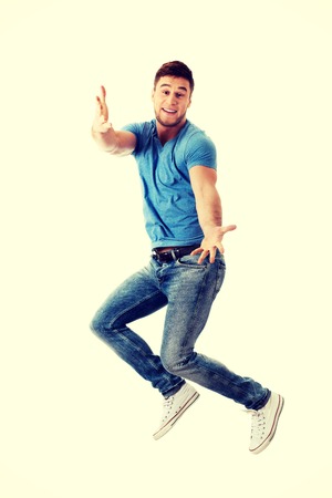Cheerful handsome man jumping for joy.の写真素材
