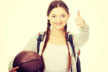 Teenager with basketball and thumbs up.の写真素材