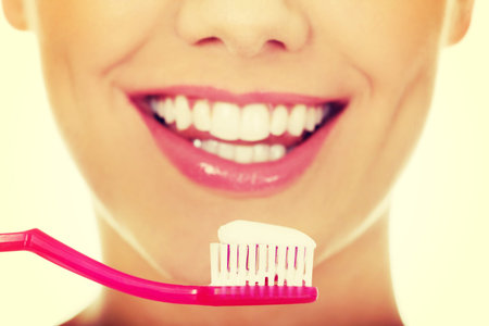 Happy woman with a toothbrush.