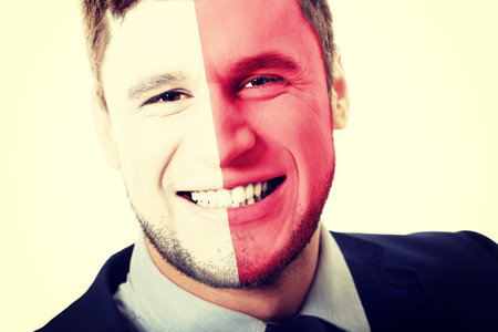 Happy man with Malta flag painted on face.