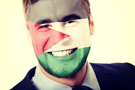 Happy man with Palestine flag painted on face.の写真素材