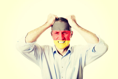 Mature man with Germany flag painted on face.の写真素材