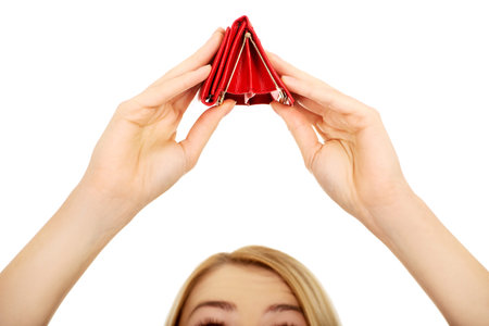 Unhappy bankrupt woman with empty wallet.