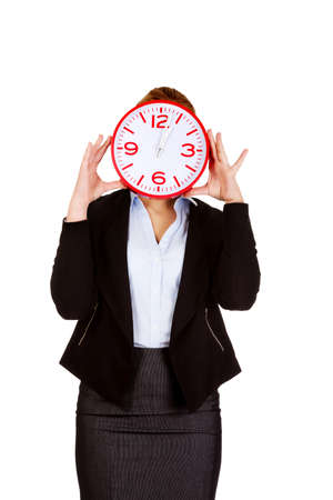 Business woman covering face with a clock.の写真素材