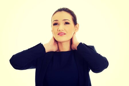 Businesswoman suffering from neck pain.の写真素材