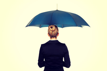 Blonde businesswoman holding an umbrella.