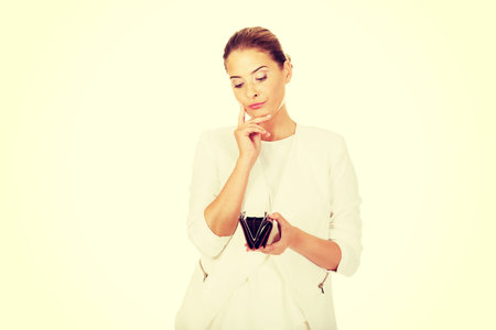 Young businesswoman holds empty wallet.