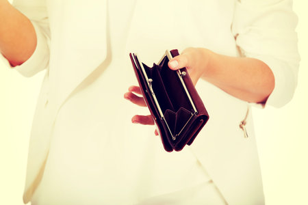 Young businesswoman holds empty wallet.
