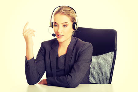 Call center woman sitting at the desk.の写真素材
