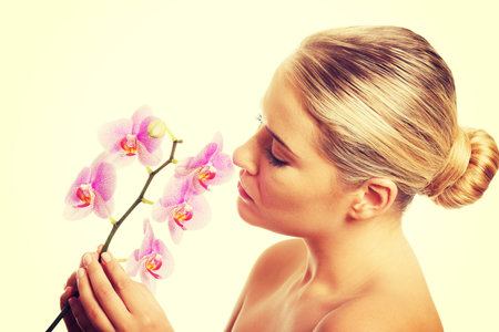 Beautiful spa woman with purple orchid flower.の写真素材