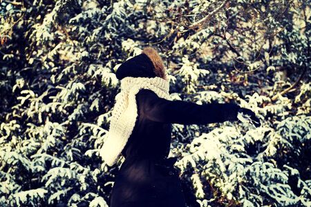 Teenage woman playing snowball fightの写真素材