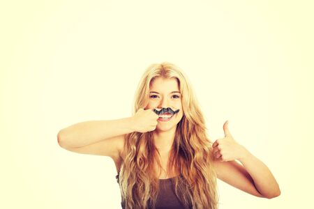 Blonde student with mustache looking at camera.の写真素材