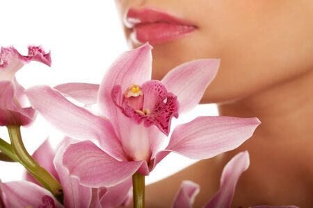 Young beautiful woman with pink flower.の写真素材