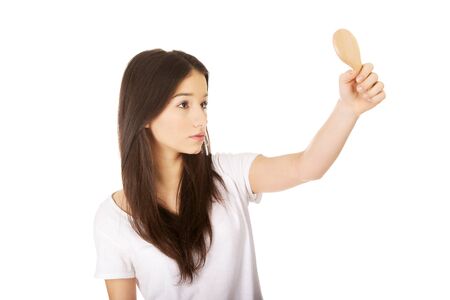 Young teenage woman holding a mirror.の写真素材