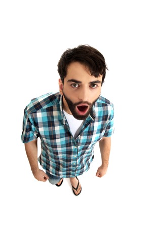 Young handsome shocked man with mouth open.の写真素材