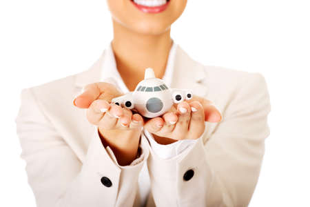 African businesswoman holding small plane on palm.の写真素材