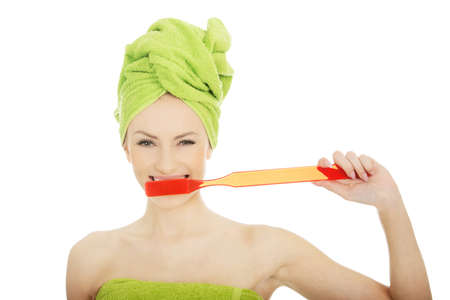 Beautiful caucasian woman with oversized toothbrush.の写真素材