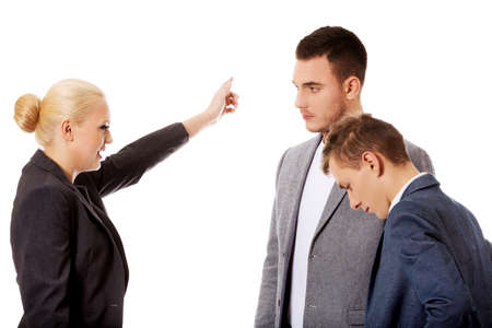 Angry boss businesswoman screaming at her employees.の写真素材