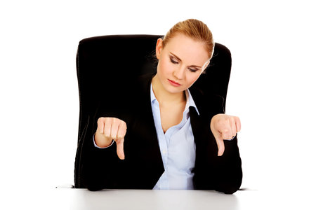 Unhappy business woman with thumbs down.