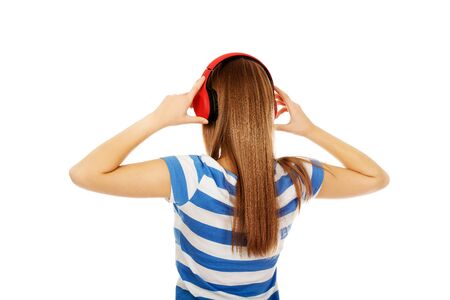 Teenage woman with red headphones.の写真素材