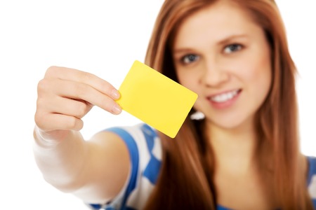 Teenage woman holding empty business card.の写真素材