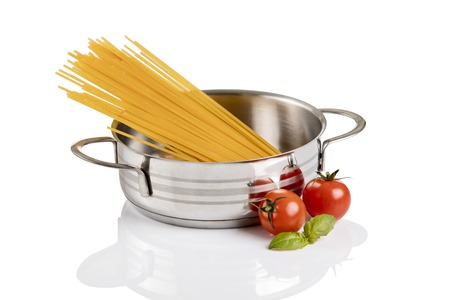 Raw pasta in metallic pot isolated on white background.の写真素材